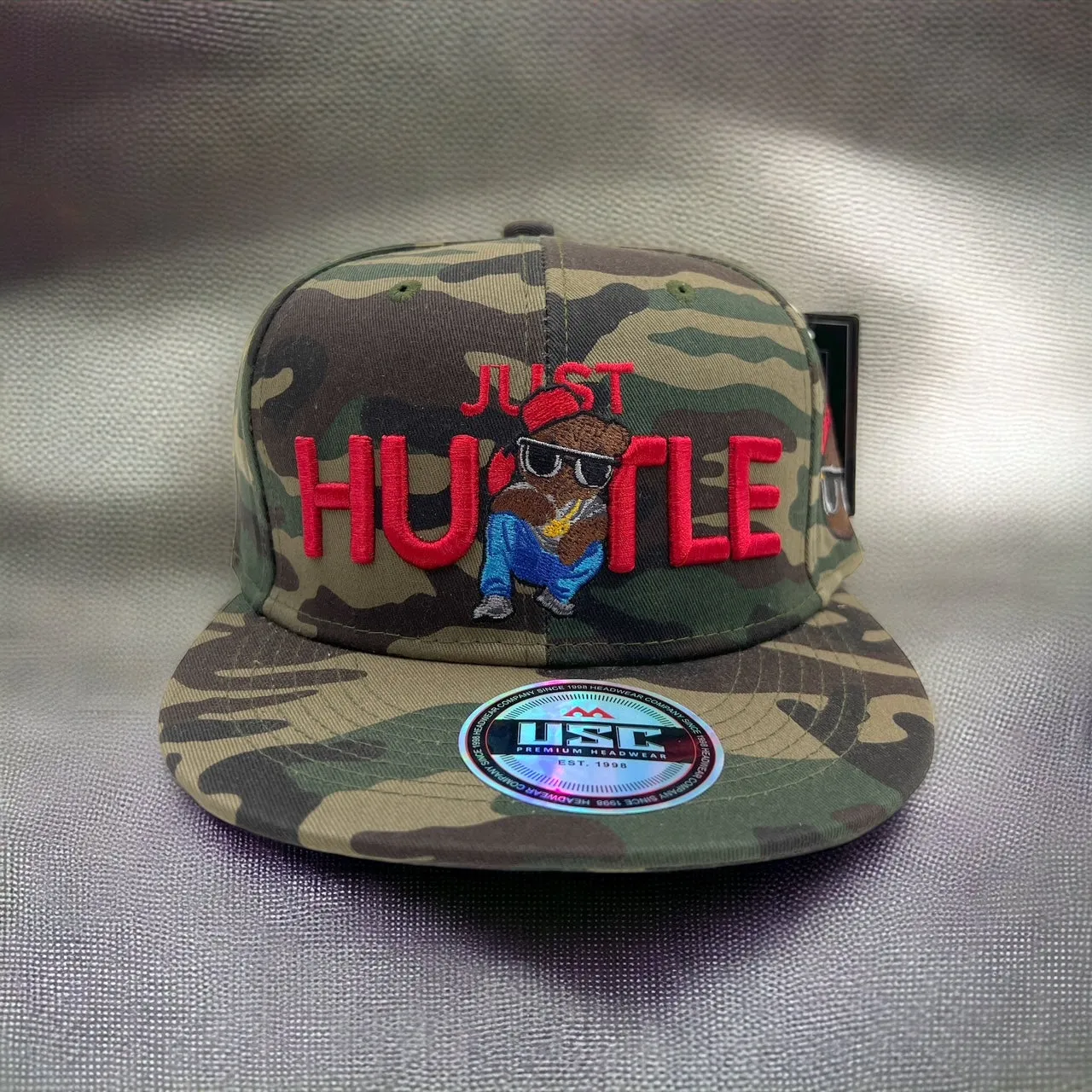 US Cotton Just Hustle Snapback Hat (Wood Camo) / 2 for $15